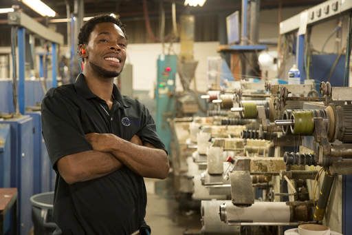 Quantum technician beside a weaving line